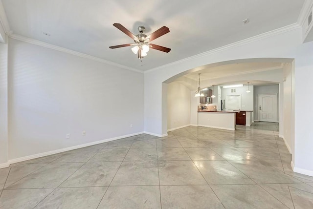 empty room with crown molding, light tile patterned floors, and ceiling fan