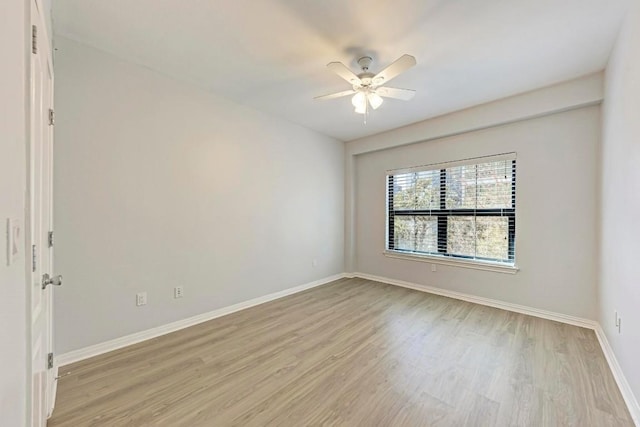 spare room featuring ceiling fan and light hardwood / wood-style floors