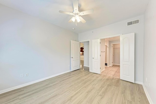 unfurnished bedroom featuring light hardwood / wood-style floors and ceiling fan