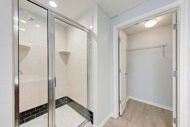 bathroom with walk in shower and hardwood / wood-style flooring