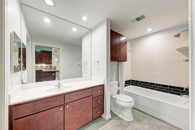 full bathroom with tile patterned floors, vanity, toilet, and tiled shower / bath combo