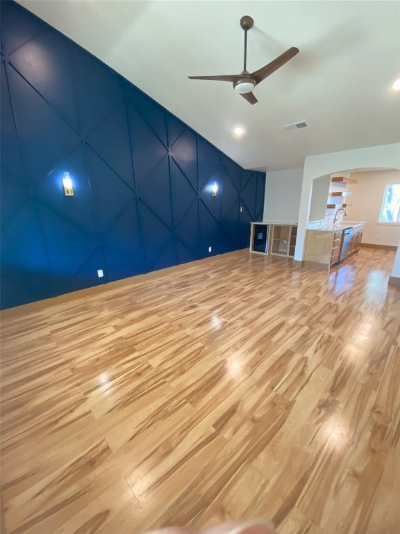 5801 Thunderbird St Unit A15, Lago Vista, TX 78645 - unfurnished living room with light wood-style flooring, a ceiling fan, and arched walkways