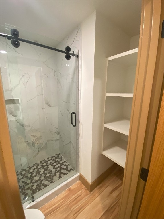 bathroom featuring wood-type flooring and walk in shower