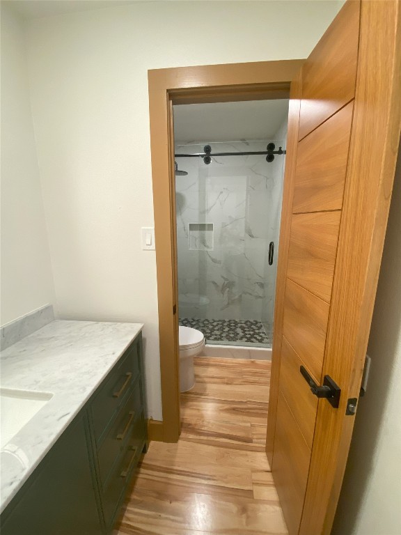 5801 Thunderbird St Unit A15, Lago Vista, TX 78645 - bathroom featuring wood finished floors, a marble finish shower, and vanity