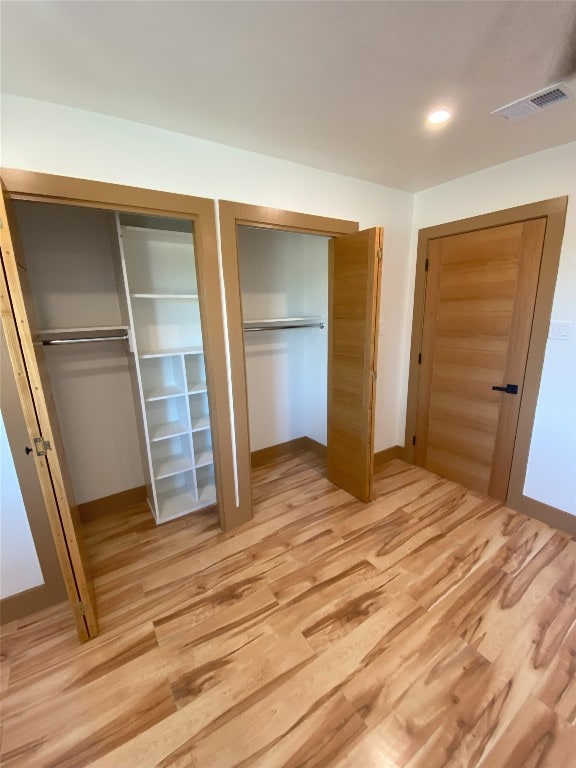 5801 Thunderbird St Unit A15, Lago Vista, TX 78645 - unfurnished bedroom with two closets and light wood-type flooring