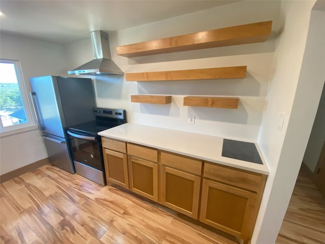 5801 Thunderbird St Unit A15, Lago Vista, TX 78645 - kitchen featuring stainless steel appliances, open shelves, wall chimney range hood, light wood-style flooring, and light countertops