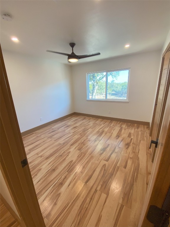 unfurnished room featuring ceiling fan and light hardwood / wood-style flooring