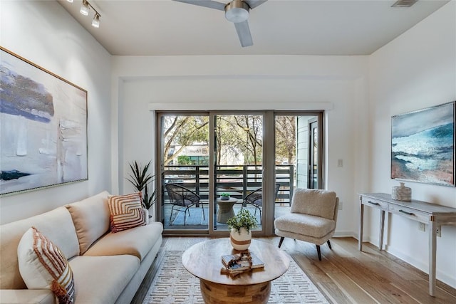 living room featuring ceiling fan and light wood-type flooring