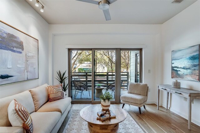 3600 S Lamar Blvd Unit 115, Austin, TX 78704 - living area with wood finished floors, ceiling fan, and baseboards