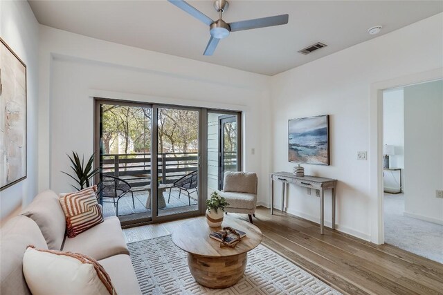 3600 S Lamar Blvd Unit 115, Austin, TX 78704 - living room featuring plenty of natural light, wood finished floors, ceiling fan, and baseboards