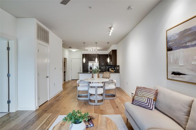 3600 S Lamar Blvd Unit 115, Austin, TX 78704 - living room featuring light wood-style flooring and baseboards