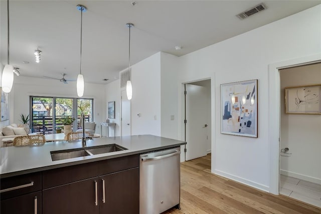 kitchen featuring hanging light fixtures, light wood-type flooring, stainless steel dishwasher, and dark brown cabinetry