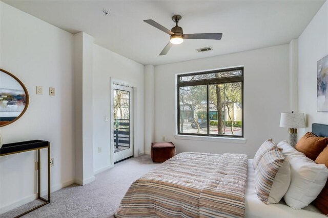 3600 S Lamar Blvd Unit 115, Austin, TX 78704 - bedroom with light carpet, access to exterior, ceiling fan, and baseboards