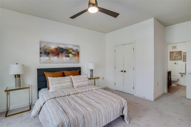 3600 S Lamar Blvd Unit 115, Austin, TX 78704 - bedroom featuring baseboards, light carpet, a closet, connected bathroom, and ceiling fan