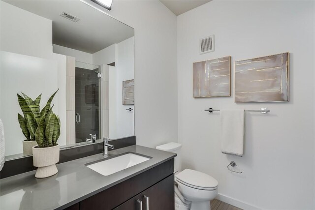 3600 S Lamar Blvd Unit 115, Austin, TX 78704 - bathroom with vanity, a tile shower, and toilet