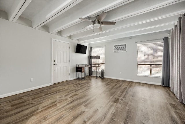 unfurnished living room featuring beamed ceiling, wood-type flooring, a wall mounted AC, and ceiling fan