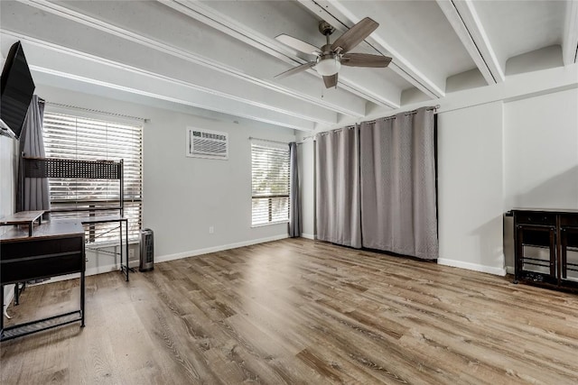 living room with hardwood / wood-style flooring, ceiling fan, beam ceiling, and an AC wall unit