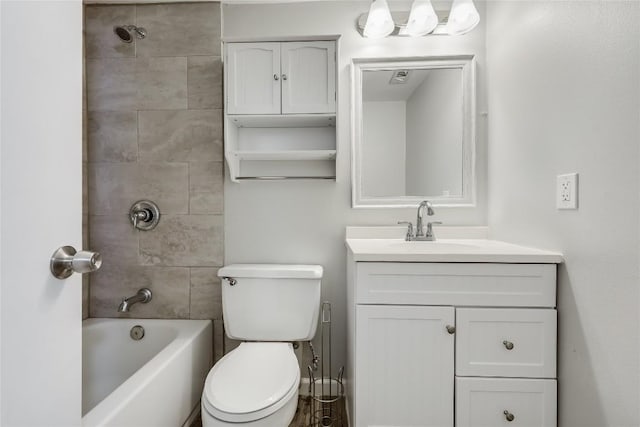 full bathroom featuring vanity, tiled shower / bath combo, and toilet