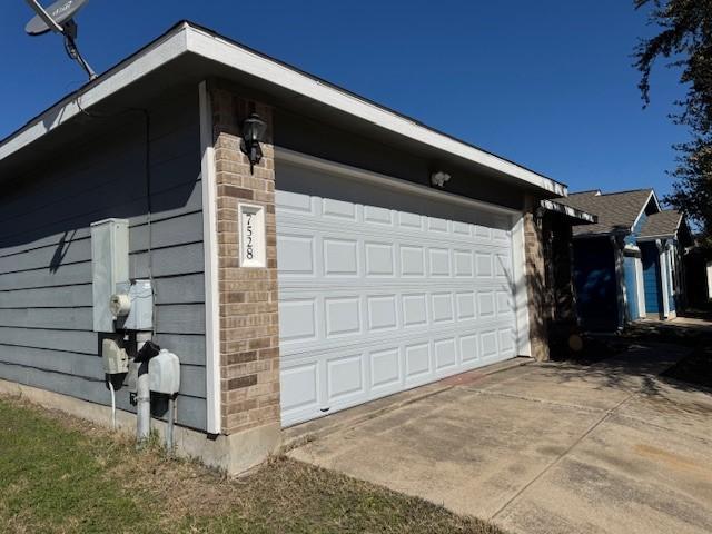 garage featuring concrete driveway