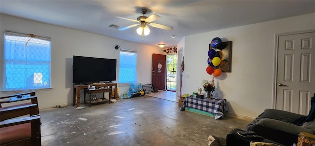 living room featuring concrete floors and ceiling fan