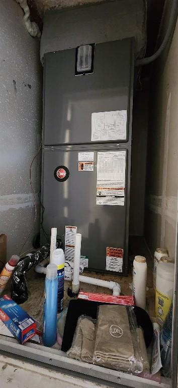 utility room featuring heating unit