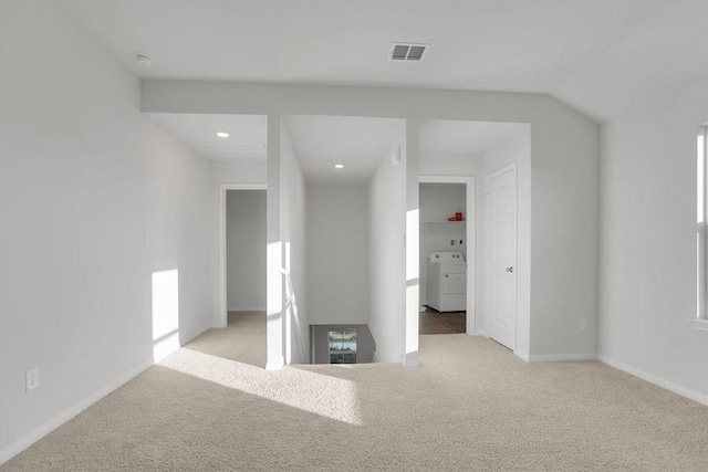 carpeted empty room featuring washer / dryer