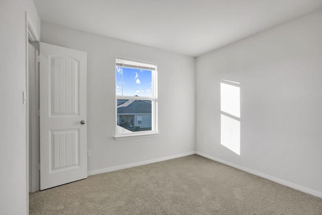 empty room featuring light carpet