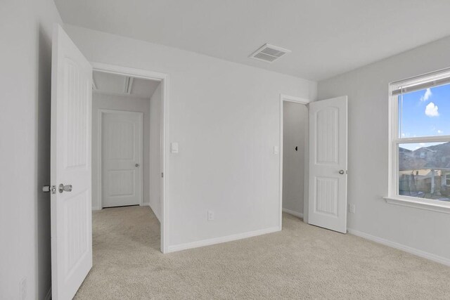 unfurnished bedroom with light carpet