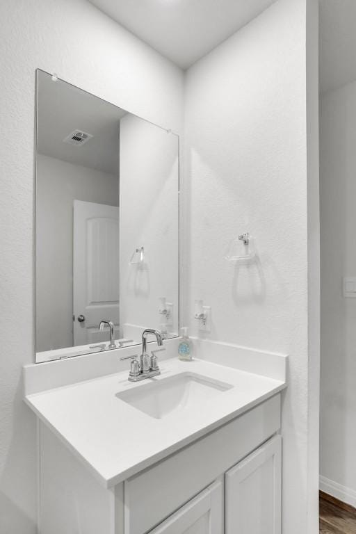 bathroom with vanity and hardwood / wood-style floors