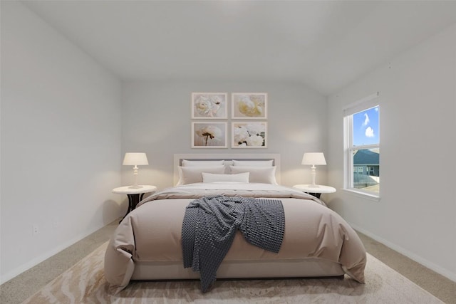 carpeted bedroom with vaulted ceiling