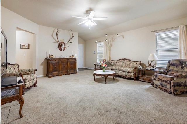 living room featuring lofted ceiling, plenty of natural light, ceiling fan, and carpet