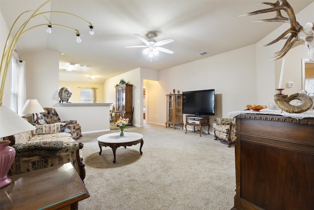 living room with lofted ceiling, light colored carpet, and ceiling fan