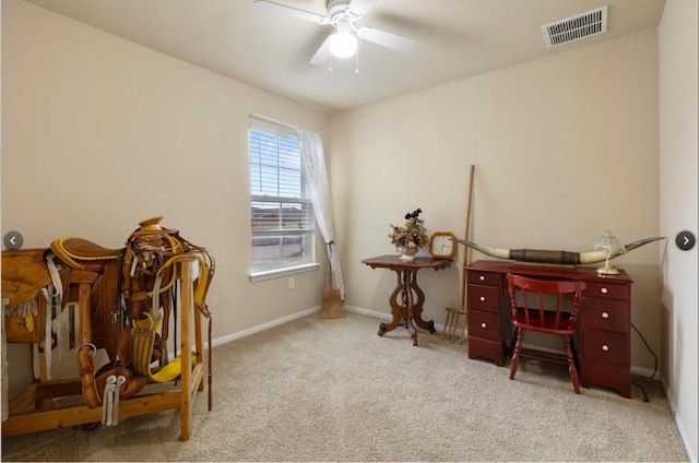 carpeted office space featuring ceiling fan