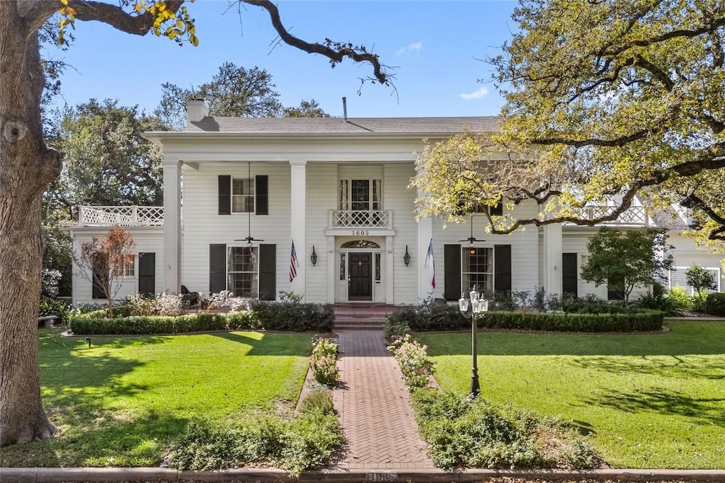 neoclassical / greek revival house with a front lawn