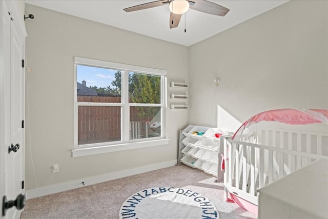 bedroom featuring light colored carpet and ceiling fan