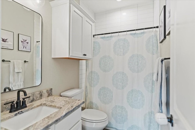 bathroom with vanity, toilet, and curtained shower