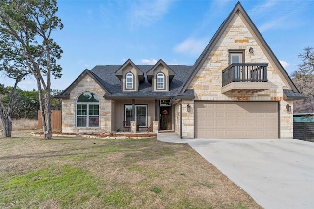 view of front of house with a balcony, a garage, and a front yard