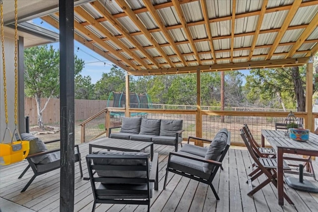 deck with outdoor lounge area and a trampoline