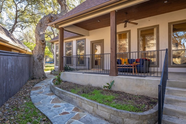 doorway to property featuring ceiling fan, an outdoor hangout area, and a patio area