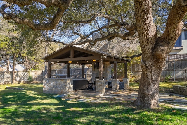 surrounding community with a gazebo, a lawn, and exterior kitchen