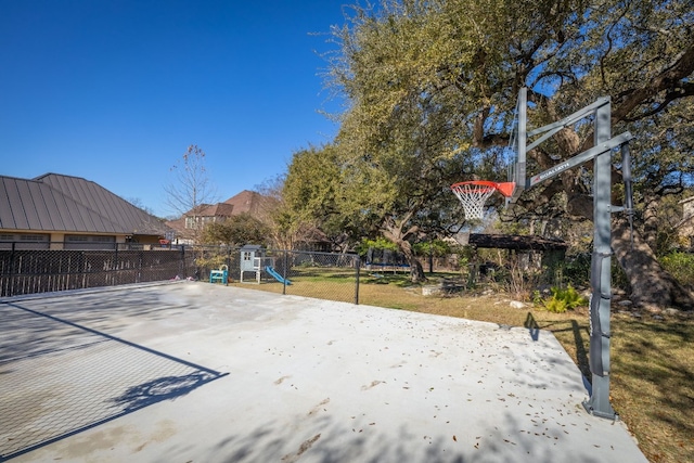 view of sport court with a playground