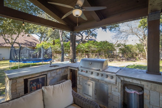 view of patio / terrace featuring wine cooler, an outdoor kitchen, sink, and area for grilling