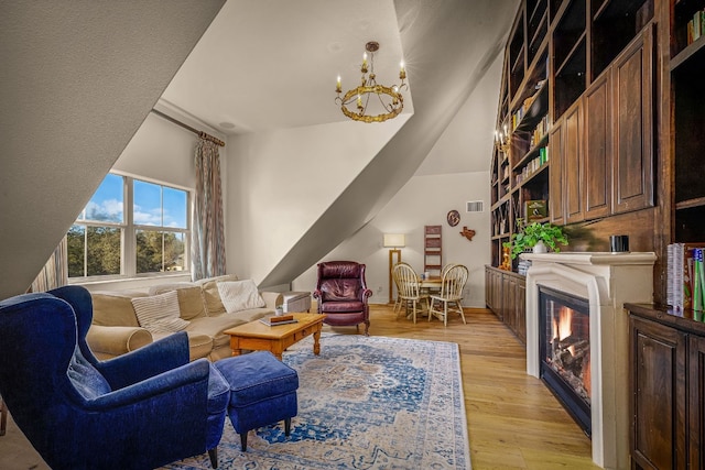 living room with an inviting chandelier and light wood-type flooring