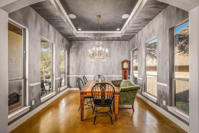 sunroom featuring a tray ceiling and a chandelier