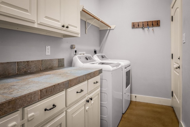 washroom with washer and clothes dryer and cabinets