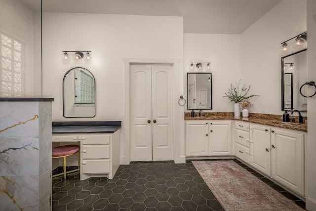 bathroom featuring tile patterned flooring and vanity