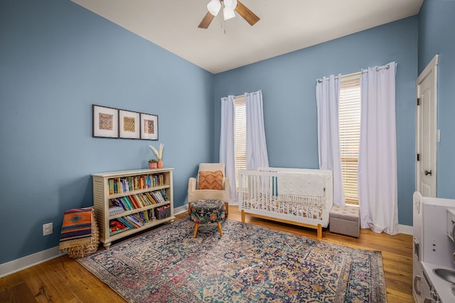 sitting room with ceiling fan, wood-type flooring, and a healthy amount of sunlight