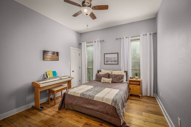 bedroom with ceiling fan and light wood-type flooring