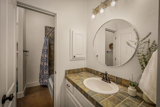 bathroom featuring vanity and shower / bathtub combination with curtain