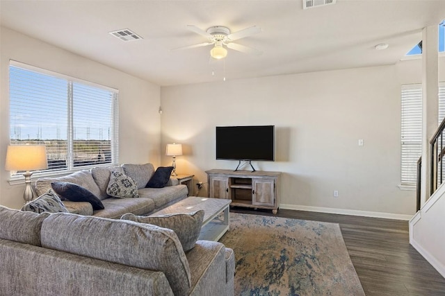 living room with dark hardwood / wood-style floors and ceiling fan